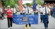  ?? TANIA BARRICKLO — DAILY FREEMAN ?? Members from Joyce-Schirick Veterans of Foreign Wars Post No. 1386 in the town of Ulster, N.Y. march down Broadway as part of Monday’s Kingston Memorial Day Parade.