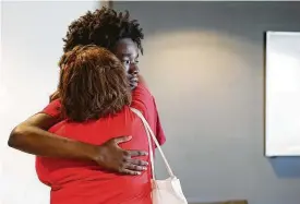  ?? Elizabeth Conley / Staff photograph­er ?? Marc Wilson, 18, sheds a tear as he gets a hug from his mom, Dana Jorsling, after they finish moving him into his dorm room Saturday at the University of Houston.