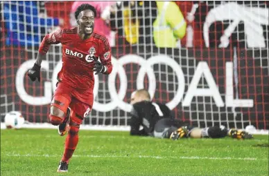  ?? The Canadian Press ?? Toronto FC forward Tosaint Ricketts celebrates after scoring against Montreal Impact goalkeeper Evan Bush in extra time of their MLS Eastern Conference playoff game in Toronto on Wednesday.