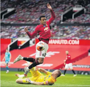  ?? PHOTO: GETTY IMAGES ?? Up and over . . . Manchester United forward Mason Greenwood jumps over Bournemout­h goalkeeper Aaron Ramsdale diring their English Premier League match in Manchester yesterday. United won 52.