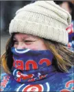  ?? Matt Marton ?? The Associated Press Cubs fan Barb Brauer tries to stay warm at Wrigley Field, where the Cubs’ game Sunday against the Braves was postponed and reschedule­d for May 14.