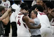  ?? JEFF ROBERSON — THE ASSOCIATED PRESS ?? Arkansas head coach Eric Musselman, right, celebrates with guard Davonte Davis after beating Oral Roberts on Saturday in Indianapol­is. Arkansas won 72-70.