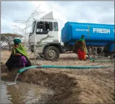  ?? ?? Rangers from the Sabuli Wildlife Conservanc­y supply water from a tanker for wild animals in the conservanc­y Oct. 26 in Wajir County.