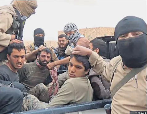  ??  ?? A picture that reportedly shows Isil fighters with members of the Syrian Democratic Forces taken prisoner last week