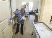  ?? Eduardo Contreras San Diego Union- Tribune ?? SAN DIEGO County says 1,037 nursing home residents have tested positive for COVID- 19 this year. Above, Mina Montano cleans at a Chula Vista facility.