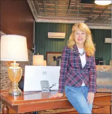  ?? SAM PIERCE/TRILAKES EDITION ?? Gurdon Mayor Sherry Kelley sits inside the new business center at the century-old First National Bank building, 106 Main St. in downtown Gurdon. The business center is equipped with five desktop computers, a wireless printer and a 55-inch flat-screen...