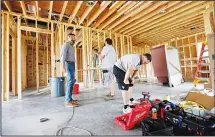  ?? (AP) ?? In this file photo, Zach Tyson (left), owner of Tyson Constructi­on, talks to electricia­ns in a home he is constructi­ng in Destrahan, La General contractor­s and other small businesses in the remodeling industry can look forward to strong growth in the...