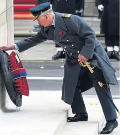  ??  ?? Prince Charles lays his wreath watched by his parents, below