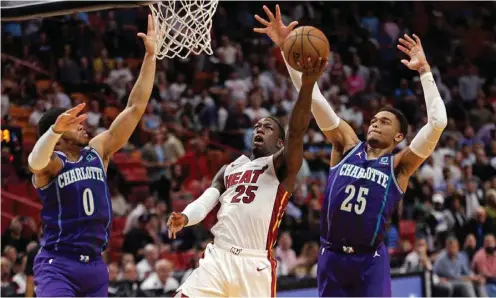  ?? (TNS) ?? Miami Heat guard Kendrick Nunn (centre) in action against the Charlotte Hornets during a regular NBA game at the AmericanAi­rlines Arena in Miami on March 11, 2020.