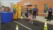  ?? DAN SOKIL — MEDIANEWS GROUP ?? Five-year-old Rylee Levonski of Lansdale, center, celebrates after dunking Lansdale Police Chief Mike Trail into a dunk tank during the borough’s National Night Out celebratio­ns Tuesday night.