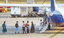  ?? PTI ?? Passengers stand in a queue to board an Indigo plane for domestic travel at Chennai airport yesterday.