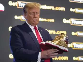  ?? AP ?? Former US president Donald Trump with his gold trainers at Sneaker Con Philadelph­ia