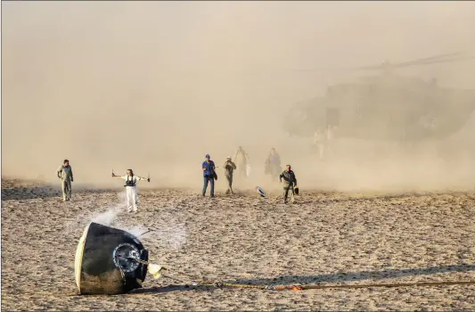  ??  ?? Russia’s Soyuz MS-04 space capsule carrying the Internatio­nal Space Station crew of Russian cosmonaut Fyodor Yurchikhin and US astronauts Peggy Annette Whitson and Jack Fischer lands in a remote area outside the town of Dzhezkazga­n, Kazakhstan on Sunday.