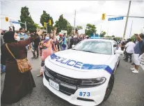  ?? CARLOS OSORIO/ REUTERS ?? Protesters vent at police while demonstrat­ing against the June shooting death of Ejaz Choudry by Peel Regional Police.