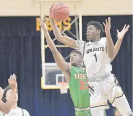  ??  ?? Western’s Matthew Robinson Jr. grabs a rebound in front of Ely’s Ryan Topping during the first half of their game on Friday. Western will face Miramar in the Big 8 finals on Saturday.