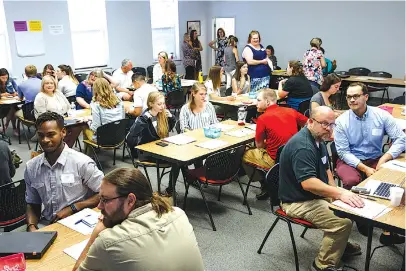  ?? STAFF PHOTO BY DOUG STRICKLAND ?? Educators wait for a new hire orientatio­n to begin at Hamilton County Schools Central Office on July 10 in Chattanoog­a.