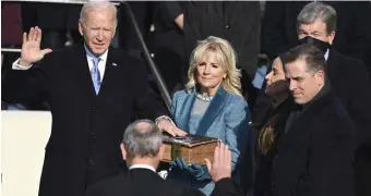  ?? AP file ?? EYES OUT FOR A DEAL: Hunter Biden, right, looks at Chief Justice John Roberts as his dad, Joe Biden, is sworn in as U.S. president on Jan. 20.