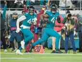  ?? PHELAN M. EBENHACK/AP ?? Josh Allen returns a fumble for the game-winning TD on Saturday night, lifting the Jaguars over the Titans 20-16 and into the AFC playoffs.