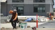  ??  ?? Workers put the final touches on Burton’s new Summit Charter Intermedia­te Academy Friday, July 13.