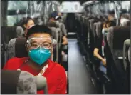  ??  ?? Hua Zhang, of the China Media Group, wears protective goggles July 14 while riding a media bus ahead of the 2020 Summer Olympics.