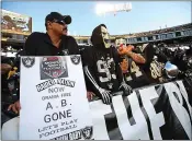  ?? JANE TYSKA — STAFF PHOTOGRAPH­ER ?? Raiders fan Jesse Contreras, of Los Angeles, left, and others watch as the team warms up before Monday’s game.