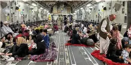  ??  ?? FLEEING: Refugees on a US military aircraft leaving Afghanista­n