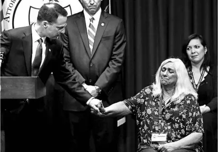  ?? MATT ROURKE/ASSOCIATED PRESS ?? Pennsylvan­ia Attorney General Josh Shapiro reaches out Tuesday to Judy Deaven, who says her son was a victim of sexual abuse by a Catholic priest.