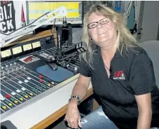  ?? LAURA BARTON/WELLAND TRIBUNE ?? Kristy Knight takes her place at the microphone at Welland radio station 91.7 Giant FM. She DJs during the afternoon for the station.