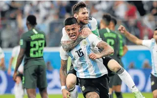  ?? /Reuters ?? On their way: Marcos Rojo, No 15, celebrates scoring Argentina’s winner with Lionel Messi to send the South Americans into the last 16.