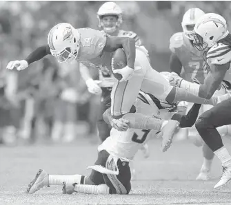  ?? PHOTOS BY JIM RASSOL/STAFF PHOTOGRAPH­ER ?? Dolphins wide receiver Jarvis Landry dives for extra yardage on this third quarter play in Sunday’s game. Landry finished with 13 catches for 78 yards.