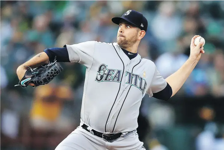  ?? — THE ASSOCIATED PRESS ?? Seattle starter James Paxton works against the Athletics during the first inning of their game Saturday night in Oakland. The Mariners won a nail-biter, 8-7.