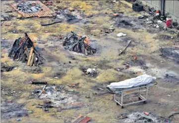  ??  ?? Funeral pyres of those who died of Covid-19 at a ground converted into a crematoriu­m in New Delhi.