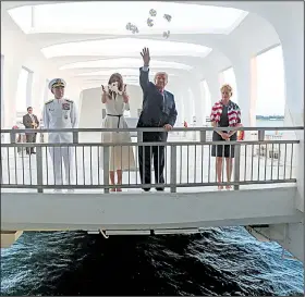  ?? AP/ANDREW HARNIK ?? President Donald Trump and his wife, Melania, cast flower petals into the water Friday at the USS Arizona memorial at Pearl Harbor, Hawaii.