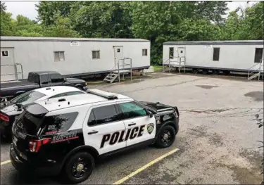  ?? TANIA BARRICKLO-DAILY FREEMAN ?? The trailers used by town of Ulster Police can be seen on Monday. Police in 2012 began using the two trailers that were placed in the Town Hall parking lot after mold was identified in the Town Hall basement.