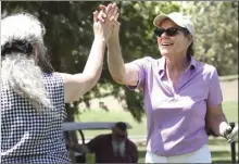  ?? Dan Watson/The Signal ?? Stacie Tarintiono, right, aunt of Derick Ryan Quintana, celebrates a good drive off the 10th tee during the Derick Ryan Quintana Memorial Golf Tournament held at Vista Valencia Golf Course.