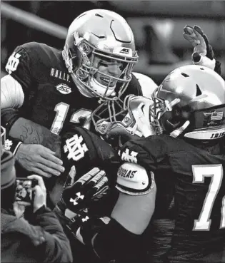  ?? MATT CASHORE/AP ?? Notre Dame quarterbac­k Ian Book celebrates after running for a touchdown Saturday.