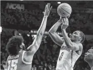  ?? Mamta Popat / Associated Press ?? Arizona’s Bennedict Mathurin shoots as he’s defended by UCLA’s Myles Johnson.