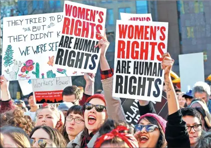  ?? KATHY WILLENS / ASSOCIATED PRESS ?? Women chant and raise their signs during a rally for equality on Wednesday, also Internatio­nal Women’s Day, in New York.