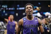  ?? The Associated Press ?? Furman guard JP Pegues (1) celebrates while leaving the court after a win against Virginia in a first-round game in the NCAA Tournament Thursday in Orlando, Fla.