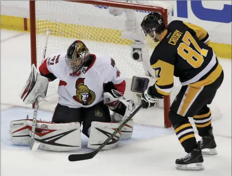  ?? PHOTO AP ?? Pittsburgh Penguins' Sidney Crosby (right) scores on Ottawa Senators goalie Craig Anderson during the first period of Game 5 in the NHL hockey Stanley Cup Eastern Conference finals Sunday in Pittsburgh.