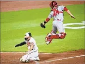  ?? Nick Wass Associated Press ?? THE ORIOLES’ Terrin Vavra slides home to score under the tag of Matt Thaiss in the fourth inning.