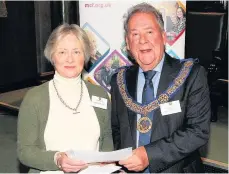  ??  ?? Pictured is David Hagger, The Provincial Grand Master of Leicesters­hire and Rutland, presenting a cheque to Janie Martin, of the Peter Le Marchant Trust.
