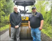  ?? Photo by Theresa Auriemmo ?? Pictured are the Regional Sales Manager for Cleveland Brothers Equipment Co. Inc., Pat Maurer, and Bill Clayson, Branch Manager for Cleveland Brothers Equipment Co. Inc., who is standing in front of the Vibratory Roller on the Knox & Kane Rail Trail near the Toby Springs area.