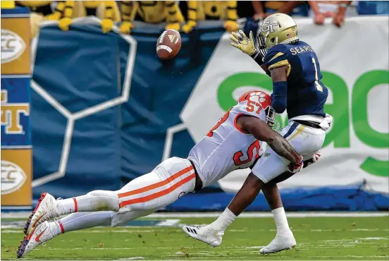  ?? HYOSUB SHIN / HSHIN@AJC.COM ?? Georgia Tech running back Qua Searcy (1) fumbles after he was hit by Clemson linebacker Tre Lamar in the first half Saturday at Bobby Dodd Stadium. The Yellow Jackets put the ball on the ground eight times, which left them one shy of matching the school’s modern-era record.