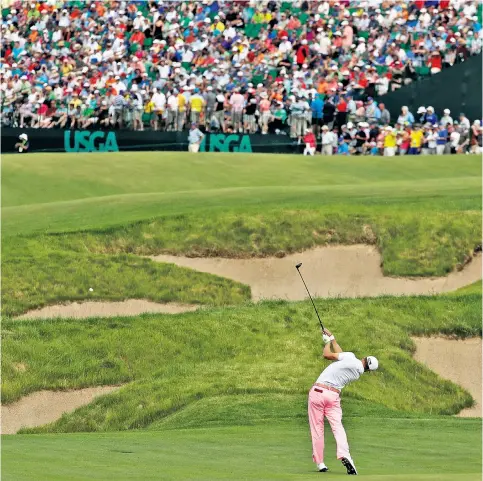  ??  ?? History maker: Justin Thomas hits to the 18th green (above) as Tommy Fleetwood (right) celebrates a birdie