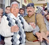  ??  ?? — PTI RJD supremo Lalu Yadav escorted by police after being convicted by the special CBI court in the fodder scam case, in Ranchi, on Saturday.