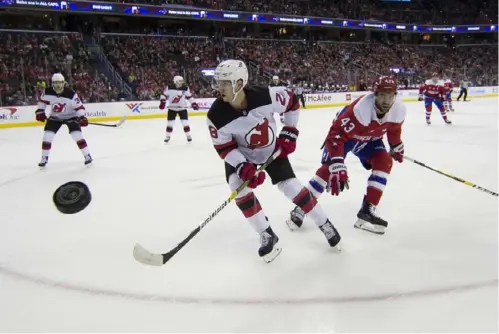  ?? The Associated Press ?? FLYING OBJECT New Jersey defenseman Damon Severson (28) and Washington right winger Tom Wilson (43) watch as the puck gets away in the first period Friday night in Washington.