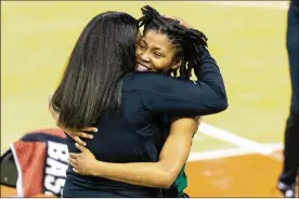  ?? AP ?? Wright State guard Angel Baker embraces coach Katrina Merriweath­er after the Raiders beat Arkansas for the school’s first NCAA Tournament win Monday in Austin, Texas. Merriweath­er believed in Baker when others at bigger schools didn’t.