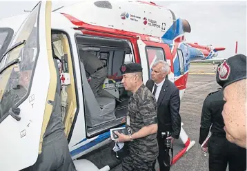  ??  ?? Thai military officials inspect the Ansat helicopter at a recent flight demonstrat­ion.