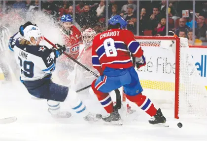  ?? ALLEN MCINNIS ?? Winnipeg winger Patrik Laine, seen crashing the crease of Habs goalie Carey Price during NHL action back in January, is said to be on the trade block. The word is, though, that the Canadiens aren't eager to trade for the Finn who has a track record of producing 30-plus goals a season.